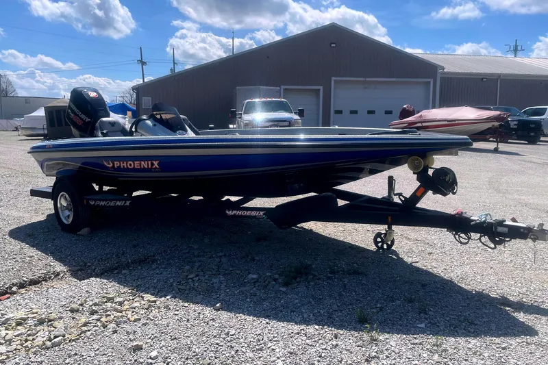 Slide: The Image of 2013 Phoenix 618 Pro boat on trailer under a cloudy sky. - 4