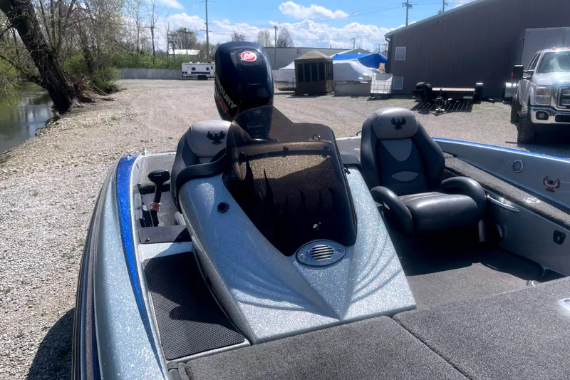 Slide: The Image of 2013 Phoenix 618 Pro boat with Mercury engine, parked on gravel near water. - 6