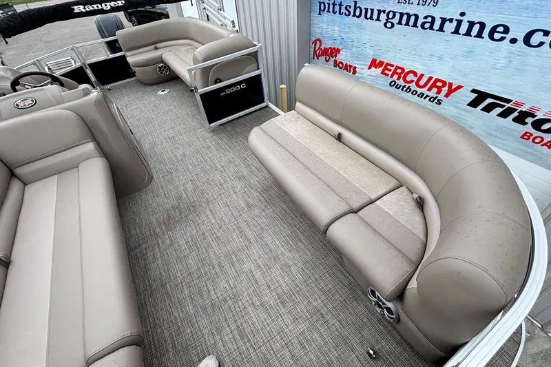 Slide: The Image of Interior of 2025 Ranger 200C boat with beige seating and carpet flooring. - 3