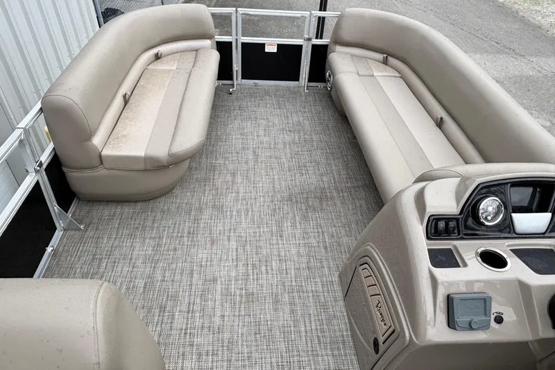 Slide: The Image of Interior of 2025 Ranger 200C pontoon boat with beige seating and control panel. - 4