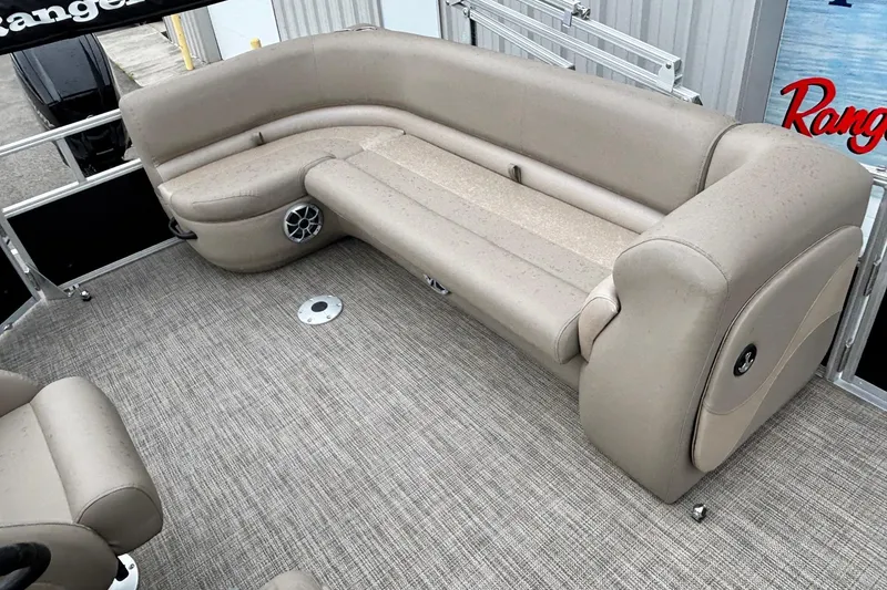 Slide: The Image of 2025 Ranger 200C boat interior with beige seating and carpeted flooring. - 7