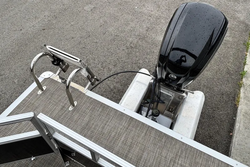 Slide: The Image of Ranger 200C 2025 boat with outboard motor and ladder on a textured deck. - 9