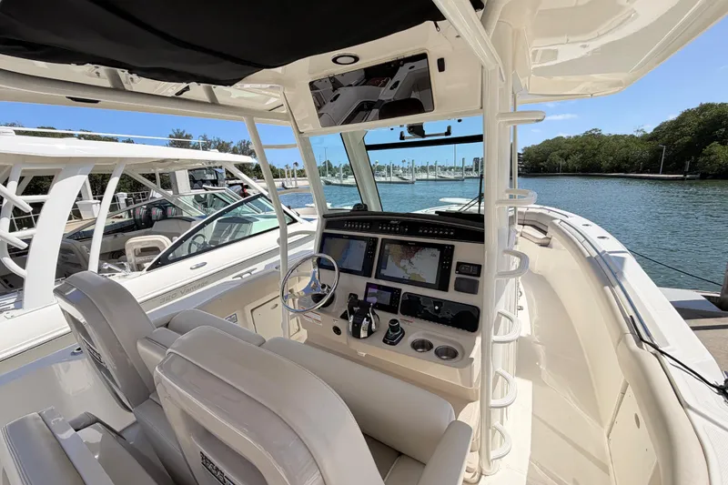 Slide: The Image of 2019 Boston Whaler 330 Outrage boat interior with navigation system and helm controls. - 18