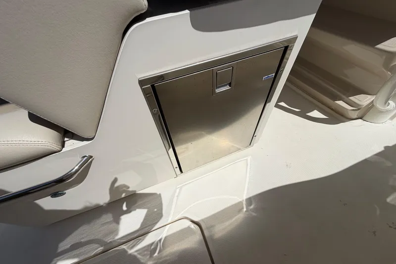 Slide: The Image of Stainless steel storage compartment on 2019 Boston Whaler 330 Outrage boat interior. - 23