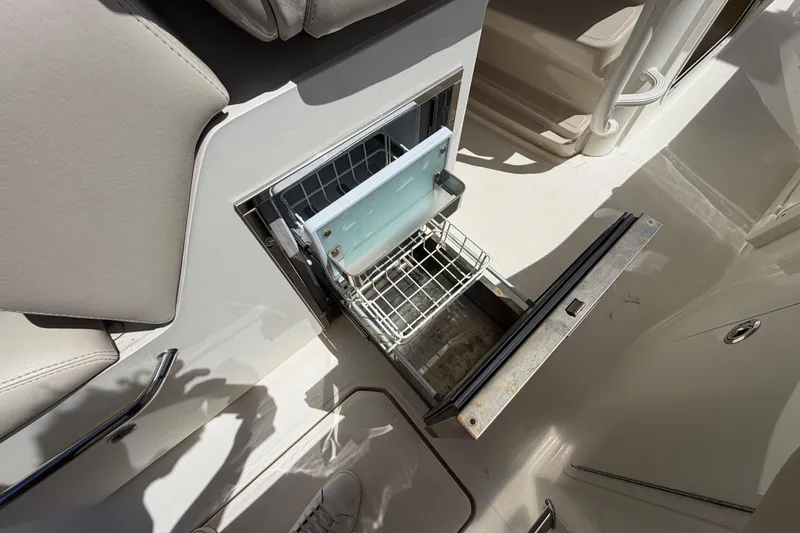 Slide: The Image of Open storage compartment on 2019 Boston Whaler 330 Outrage boat interior. - 24