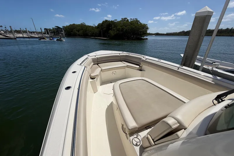 Slide: The Image of 2019 Boston Whaler 330 Outrage boat docked in a serene marina setting. - 31