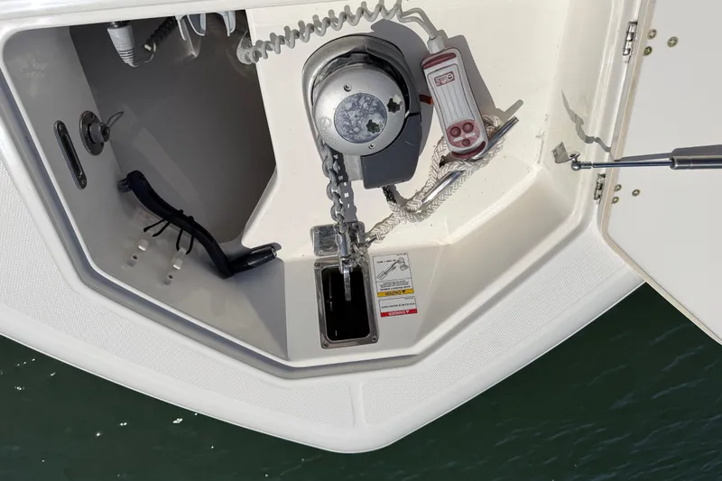Slide: The Image of Anchor compartment of 2019 Boston Whaler 330 Outrage with winch and control panel. - 37
