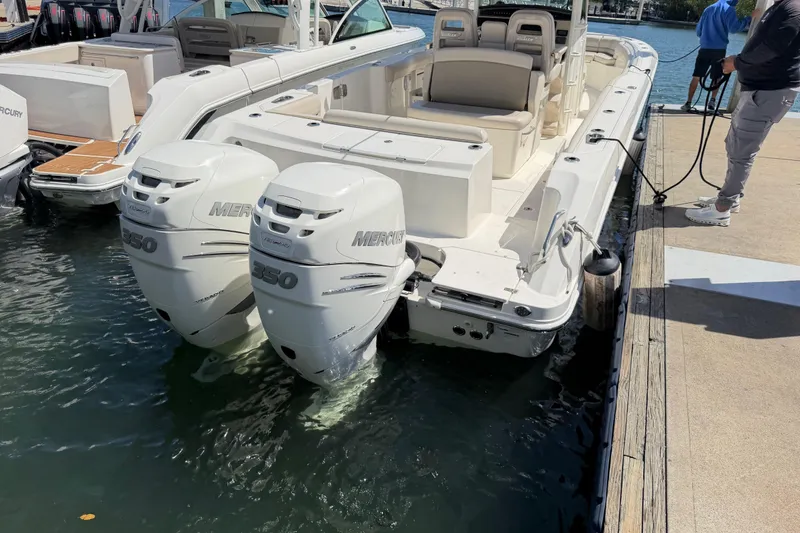 Slide: The Image of 2019 Boston Whaler 330 Outrage docked with twin Mercury engines. - 4