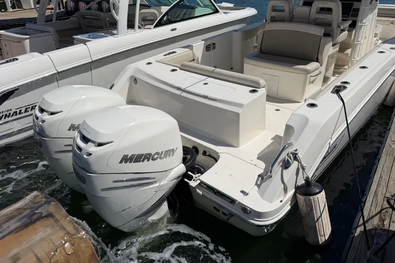 Slide: The Image of 2019 Boston Whaler 330 Outrage with twin Mercury engines docked at marina. - 5