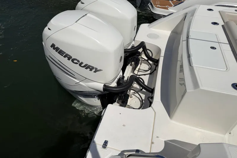 Slide: The Image of 2019 Boston Whaler 330 Outrage with dual Mercury outboard engines on water. - 6