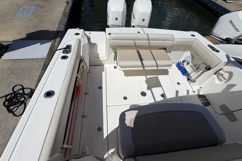 Slide: The Image of 2019 Boston Whaler 330 Outrage boat interior with seating and twin Mercury engines. - 9