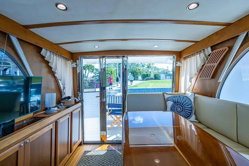 Slide: The Image of Interior of 2015 Sabre 38 Salon Express yacht, featuring elegant wood finishes and plush seating. - 10