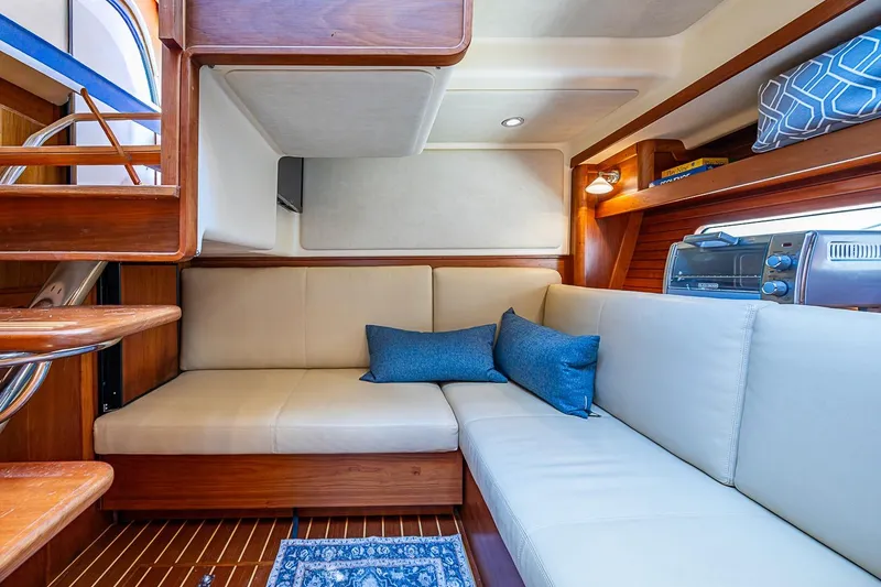 Slide: The Image of Interior of 2015 Sabre 38 Salon Express yacht with cozy seating and elegant wood finishes. - 13