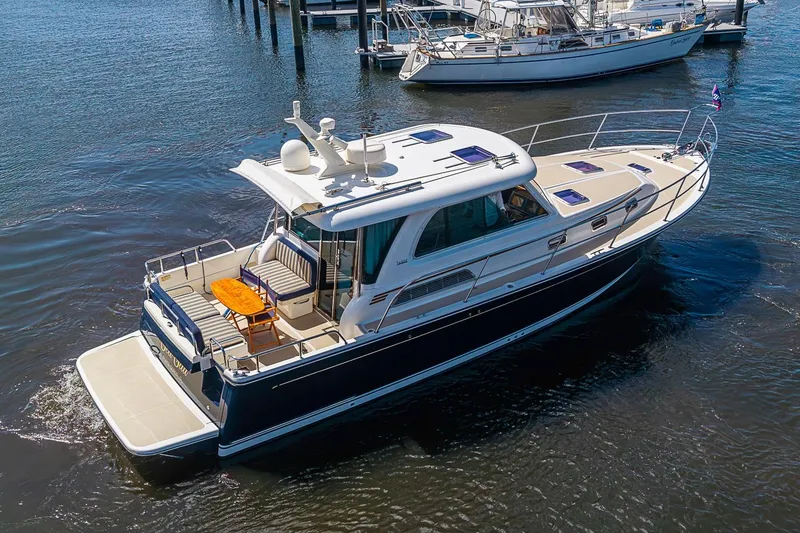 Slide: The Image of 2015 Sabre 38 Salon Express yacht cruising on calm waters, showcasing elegant design. - 2