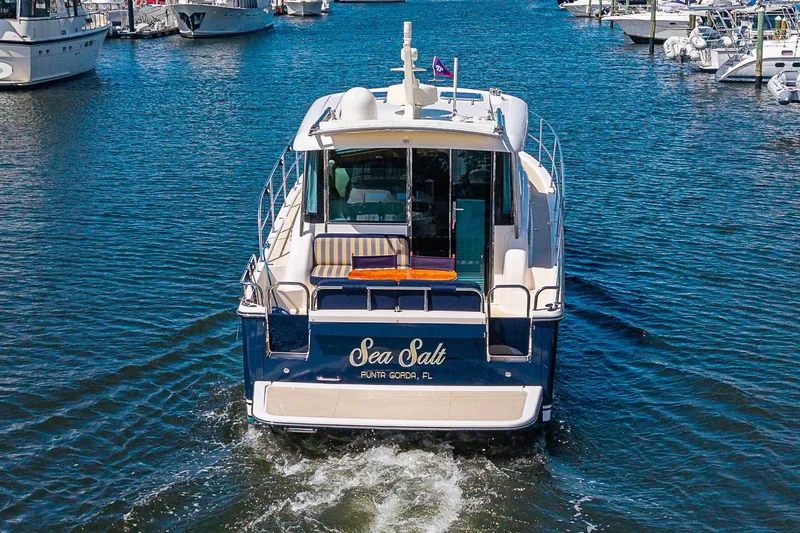 Slide: The Image of 2015 Sabre 38 Salon Express yacht named "Sea Salt" cruising in a marina. - 3