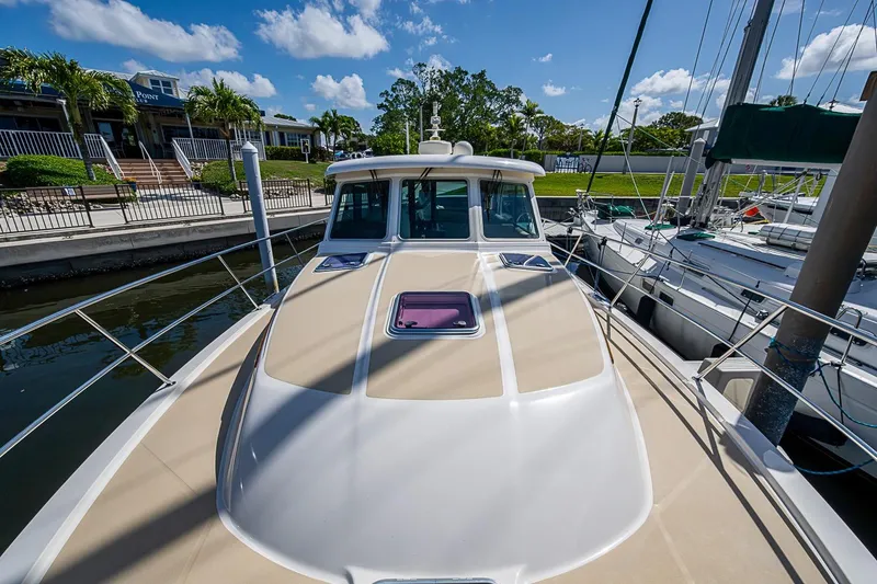 Slide: The Image of 2015 Sabre 38 Salon Express yacht docked at marina under blue sky. - 4