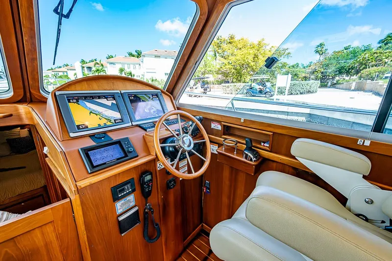 Slide: The Image of 2015 Sabre 38 Salon Express helm with navigation screens and luxurious seating. - 7