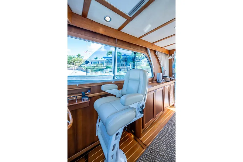 Slide: The Image of Interior of 2015 Sabre 38 Salon Express yacht with captain's chair and wooden cabinetry. - 8