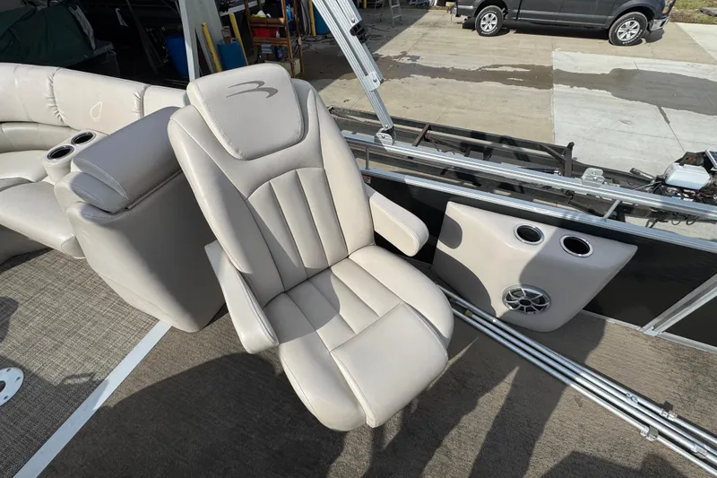 Slide: The Image of Luxurious seating on a 2014 Bennington 2550GSRB pontoon boat with cup holders and speaker. - 10
