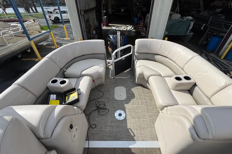 Slide: The Image of 2014 Bennington 2550GSRB pontoon boat interior with beige seating and cup holders. - 11