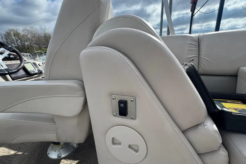 Slide: The Image of 2014 Bennington 2550GSRB boat interior with beige seating and control panel. - 13