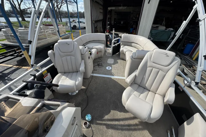 Slide: The Image of 2014 Bennington 2550GSRB pontoon boat interior with plush seating and steering console. - 7