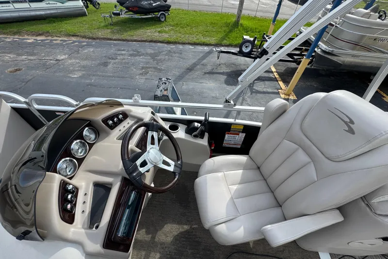 Slide: The Image of 2014 Bennington 2550GSRB boat interior with steering wheel and captain's chair. - 8