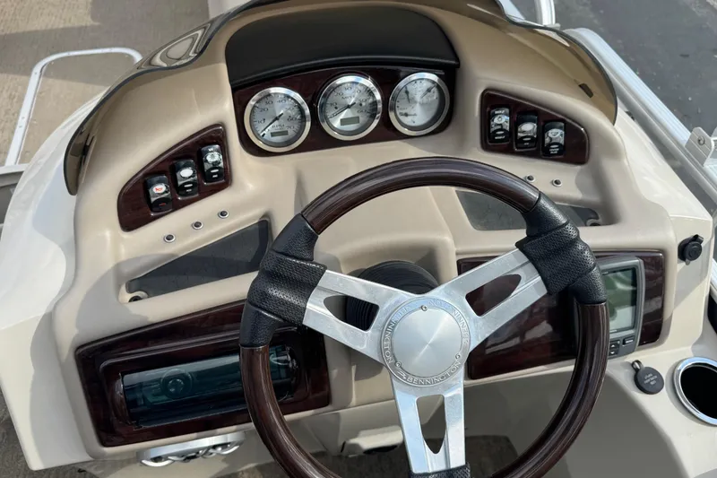 Slide: The Image of Steering console of a 2014 Bennington 2550GSRB boat with gauges and controls. - 9