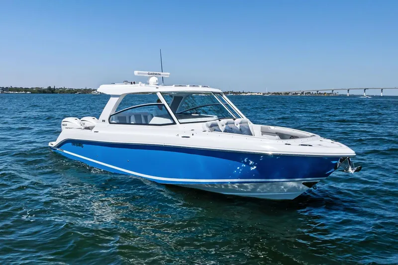 Slide: The Image of Manufacturer Provided Image: 2025 Everglades 367 CX boat cruising on open water under clear blue sky. - 5