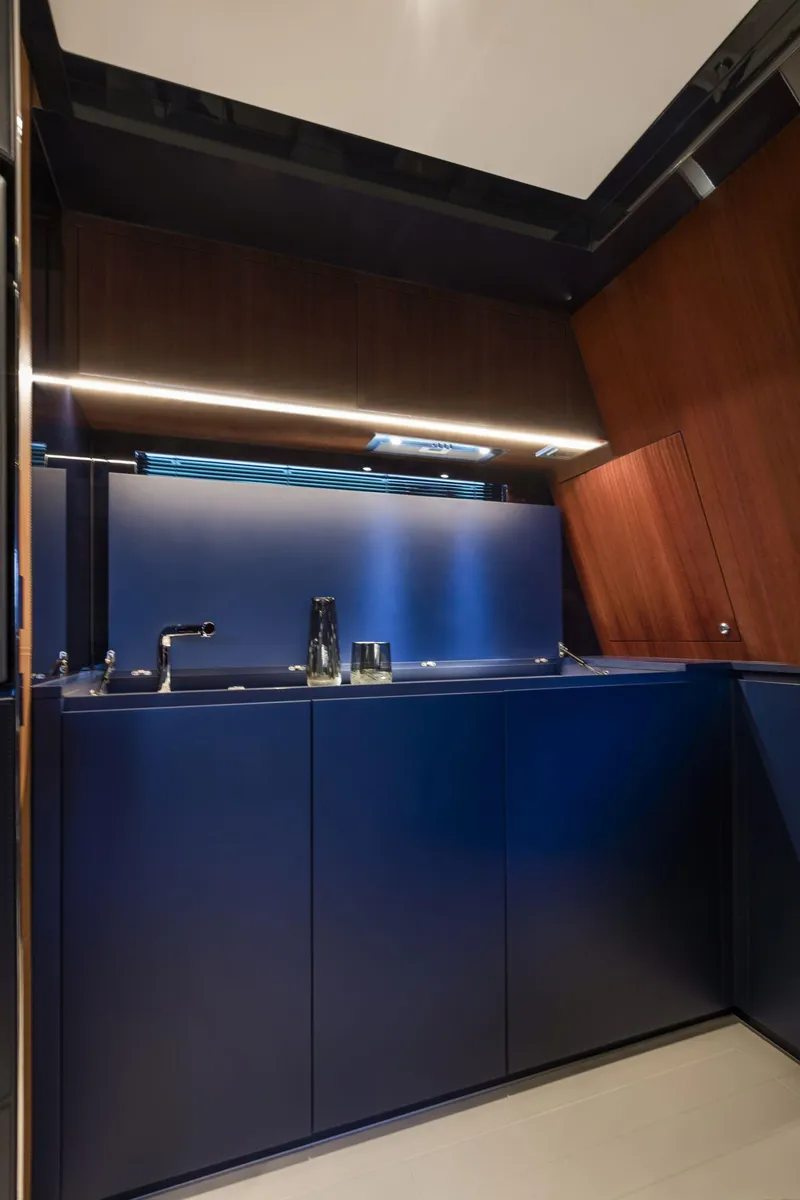 Slide: The Image of Modern kitchen area in 2021 Riva Dolceriva 48 yacht with sleek cabinetry and ambient lighting. - 24