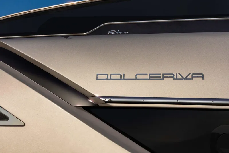 Slide: The Image of 2021 Riva Dolceriva 48 yacht close-up, showcasing sleek design and logo. - 5