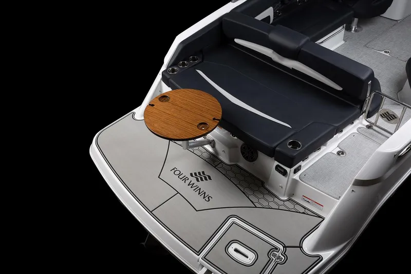 Slide: The Image of Manufacturer Provided Image: 2025 Four Winns HD8 boat deck with seating and wooden table, showcasing luxury design. - 11