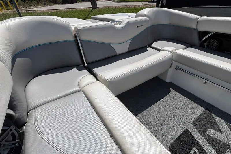 Slide: The Image of 2017 MasterCraft XT23 boat interior with gray seating and carpeted flooring. - 10