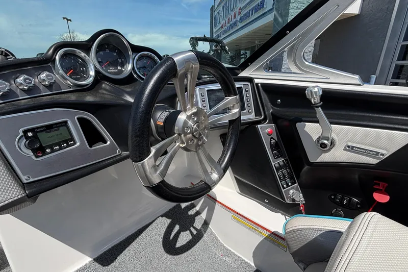 Slide: The Image of 2017 MasterCraft XT23 boat dashboard with steering wheel and control panel. - 15