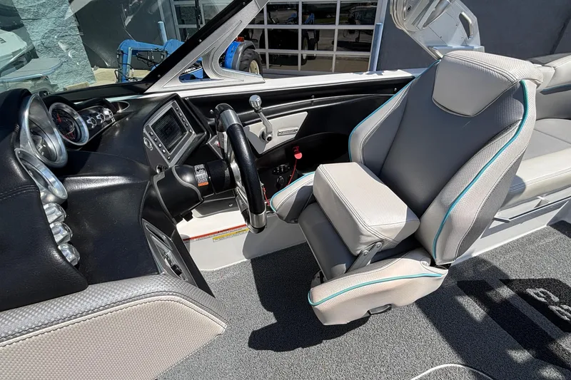 Slide: The Image of 2017 MasterCraft XT23 boat interior with steering wheel and dashboard controls. - 16