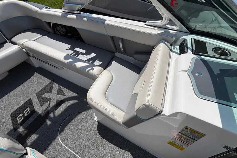 Slide: The Image of Interior of a 2017 MasterCraft XT23 boat with gray seating and carpet. - 18