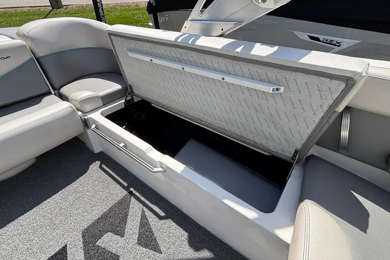 Slide: The Image of Open storage compartment in 2017 MasterCraft XT23 boat interior. - 22