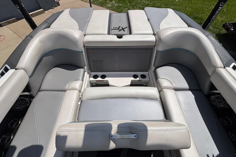 Slide: The Image of 2017 MasterCraft XT23 boat interior with gray seating and cup holders. - 25