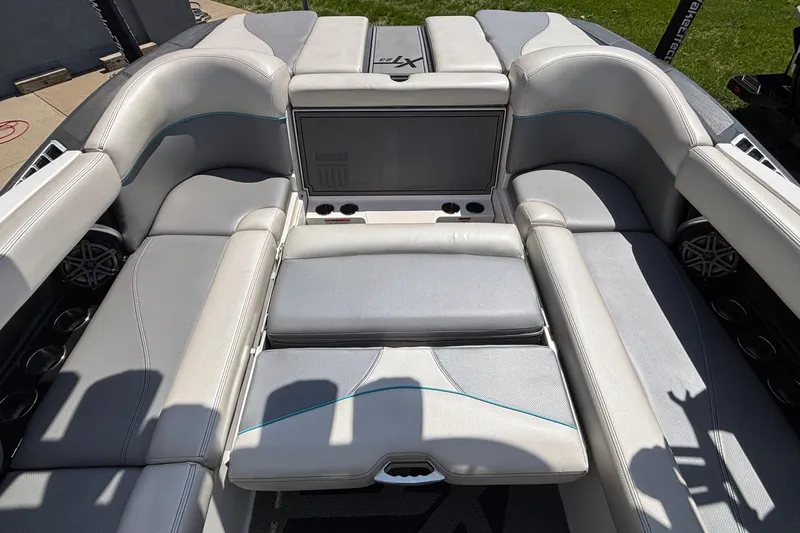 Slide: The Image of 2017 MasterCraft XT23 boat interior with gray seating and cup holders. - 26