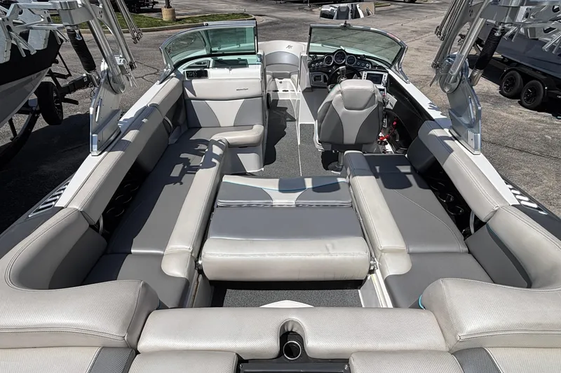 Slide: The Image of 2017 MasterCraft XT23 boat interior with spacious seating and modern dashboard. - 27