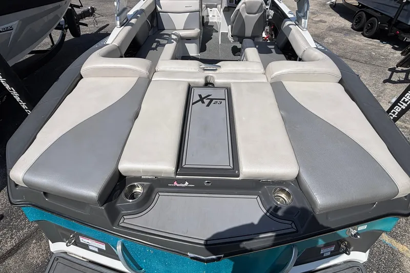 Slide: The Image of 2017 MasterCraft XT23 boat interior with cushioned seating and storage compartments. - 3