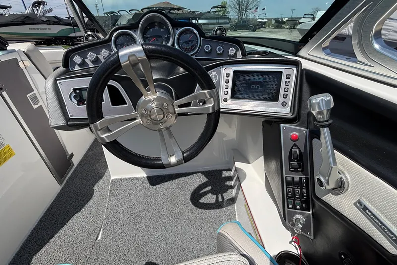 Slide: The Image of 2017 MasterCraft XT23 boat dashboard with steering wheel and control panel. - 34