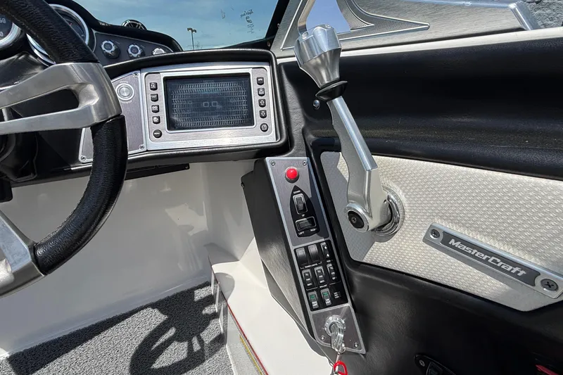 Slide: The Image of Interior of a 2017 MasterCraft XT23 boat showing steering wheel and control panel. - 35