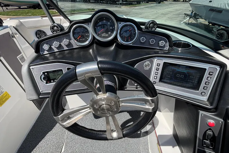Slide: The Image of 2017 MasterCraft XT23 dashboard with steering wheel, gauges, and control panel. - 36
