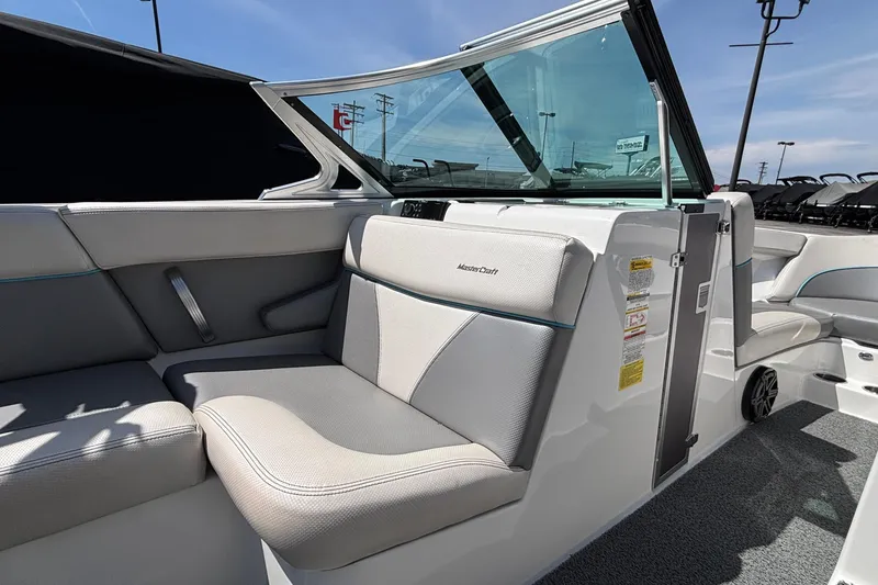 Slide: The Image of 2017 MasterCraft XT23 boat interior with gray seating and open windshield. - 38