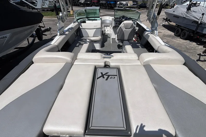 Slide: The Image of 2017 MasterCraft XT23 boat interior with spacious seating and modern dashboard. - 4