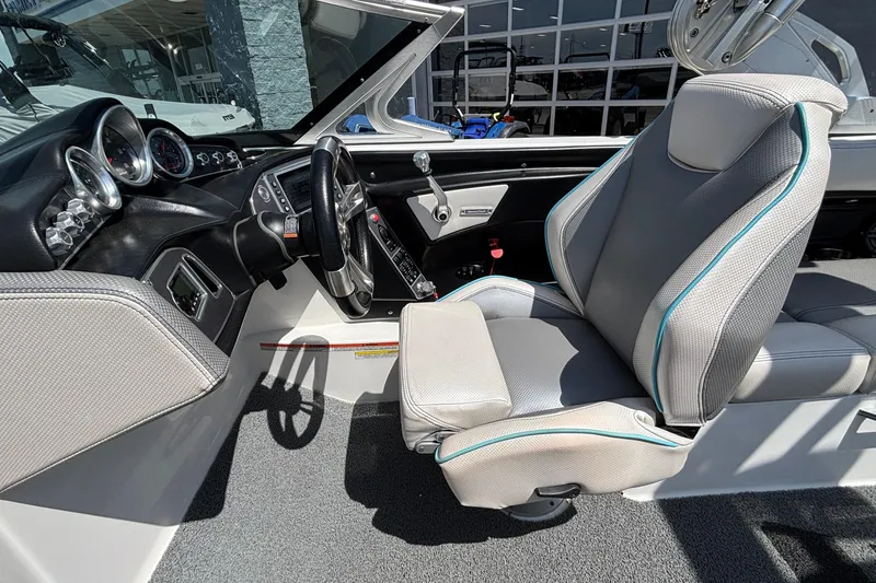 Slide: The Image of 2017 MasterCraft XT23 boat interior with steering wheel and captain's seat. - 40