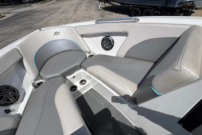 Slide: The Image of 2017 MasterCraft XT23 boat interior with gray seating and speaker system. - 46