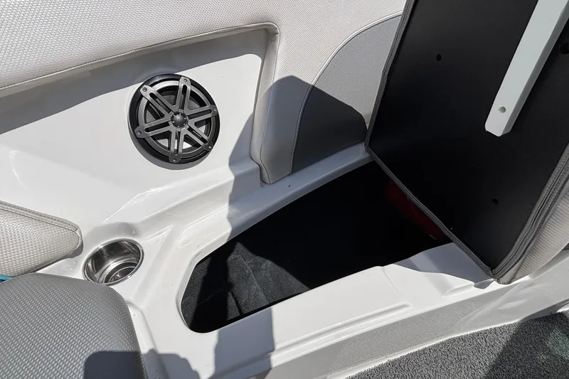 Slide: The Image of 2017 MasterCraft XT23 boat interior with speaker and storage compartment. - 49