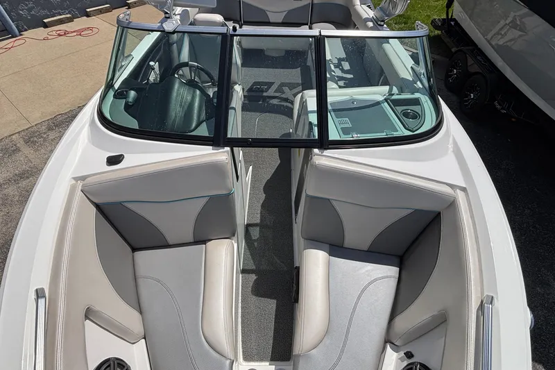Slide: The Image of 2017 MasterCraft XT23 boat interior with sleek seating and windshield view. - 51